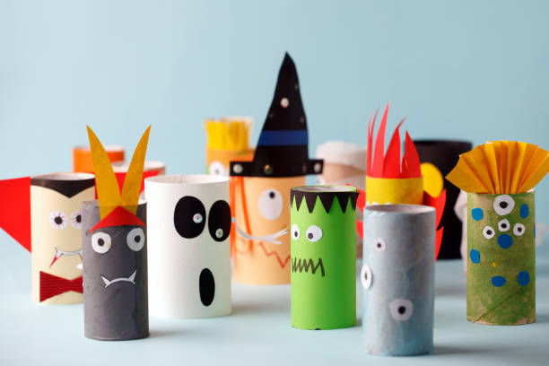 istock Halloween crafts, paper ghost, monsters on blue paper background with copy space for text. halloween concept handcraft, diy, creative idea from toilet tube, recycle 1164462414
