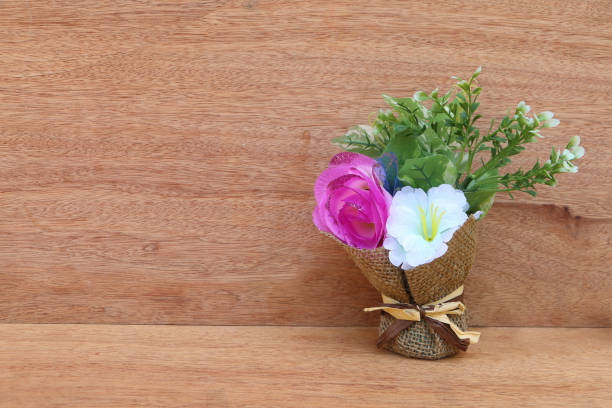 Flowers in a vase old wooden table.