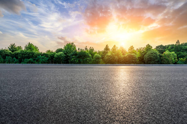 istock Asphalt highway and green forest with beautiful clouds at sunset 1164466081