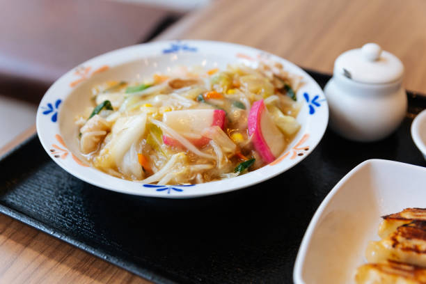 istock Champon Ramen (a noodle dish that is a regional cuisine of Nagasaki, Japan) with Pork, Shrimp, Scallion, Sprout, Carrot, Cabbage, Corn and Kamaboko. 1164470004