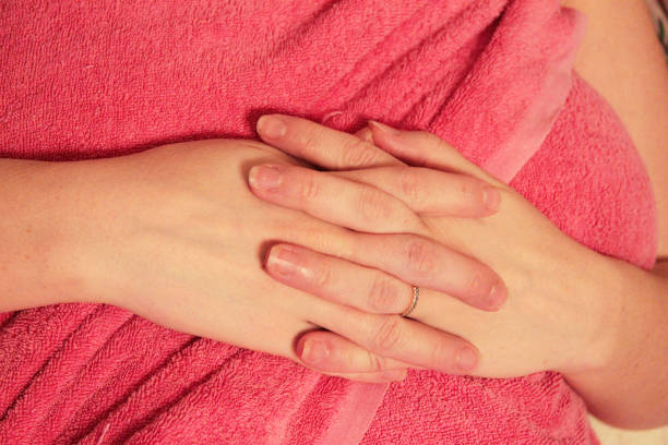 istock A womans hand on the pink background 1164470147