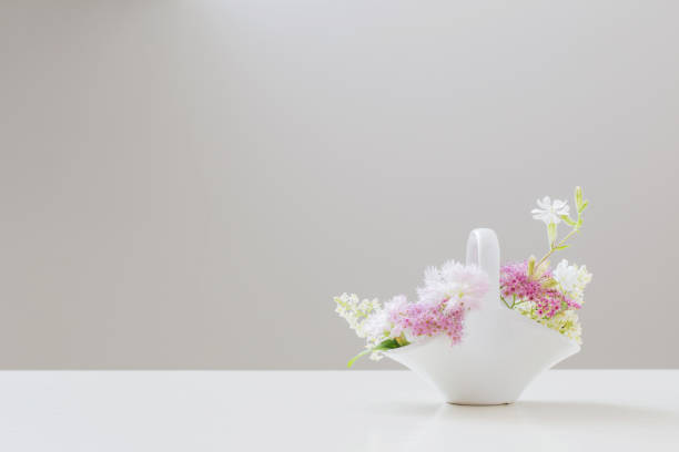 pink and white flowers in white ceramic basket