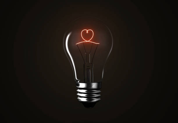 istock Lighting bulb lamp heart shape on black background, 3D rendering 1164473989