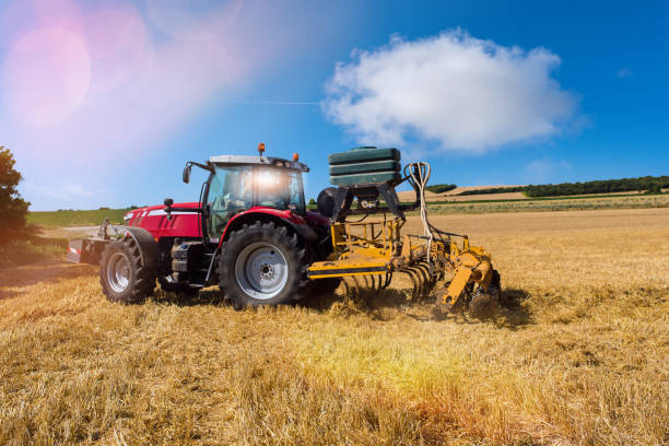 istock tractor plowing the fields after the harvest of barley 1164475971