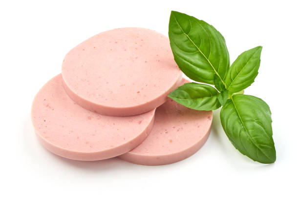 istock Salami sausage slices with basil, isolated on white background. 1164478313
