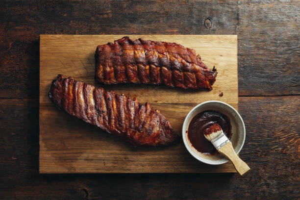 Smoke barbecue pork ribs Grilled pork ribs with barbecue sauce on wooden background barbecue pork stock pictures, royalty-free photos & images