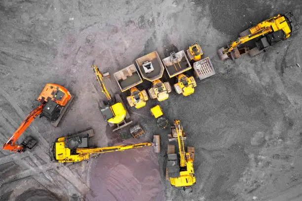 Photo of Construction site diggers yellow and orange aerial view from above