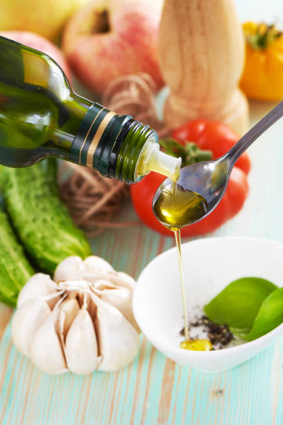 istock olive oil pouring in a spoon. 1164488806