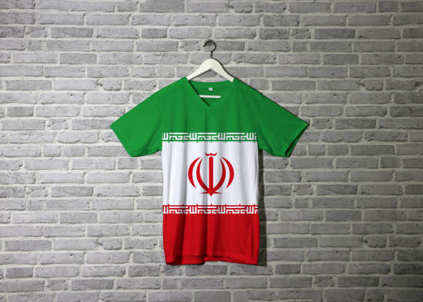 istock Iran flag on shirt and hanging on the wall with brick pattern wallpaper. 1164488813