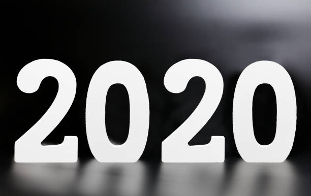 istock Year 2020 made from wooden white numbers on a black background 1164488854