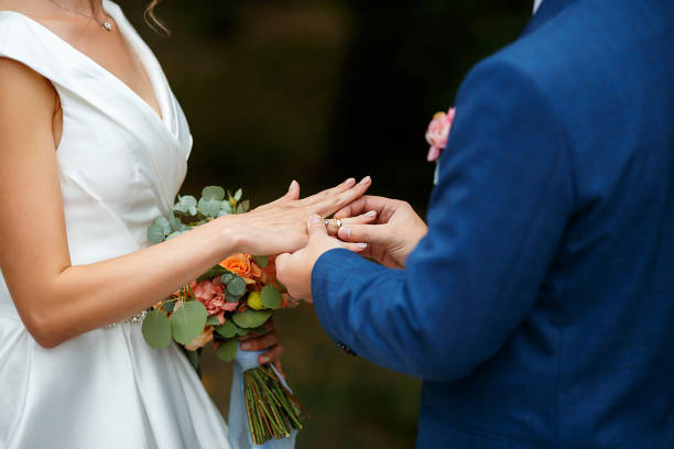 istock Newlyweds put each other rings on the ceremony 1164490044
