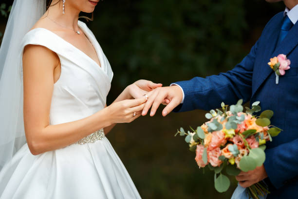 newlyweds put each other rings on the ceremony - wedding behavior horizontal men imagens e fotografias de stock