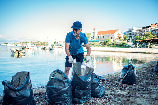 Male Volunteer Cleaning Seashore