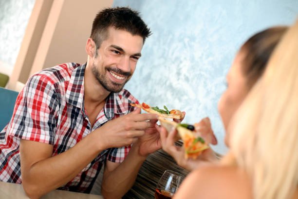 istock Smiling young couple in a pizzeria 1164498947