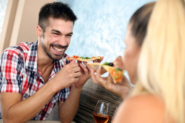 istock Young couple eating pizza 1164499115