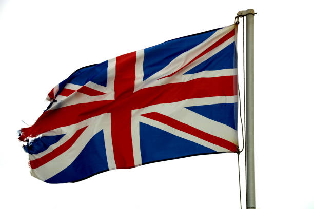 istock Tattered United Kingdom Flag Fluttering in a Breeze 1164500095
