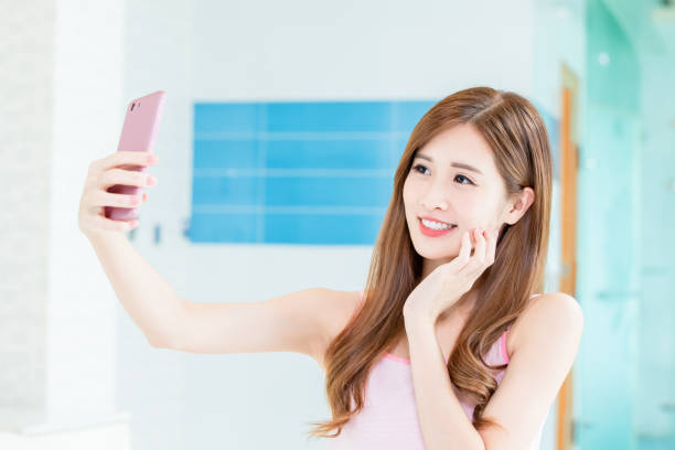 istock asian woman take selfie 1164500209
