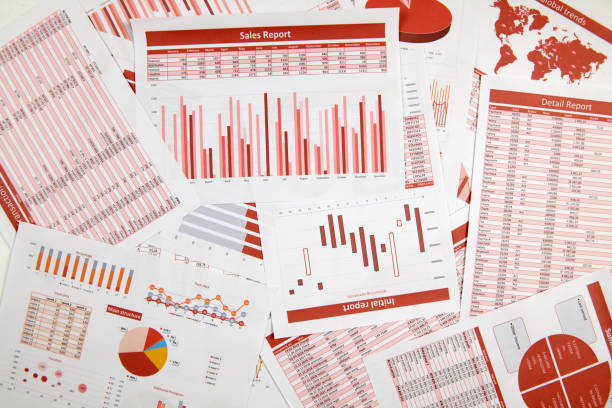 istock Business reports, data tables and charts - directly above view of office table workspace. 1164500494