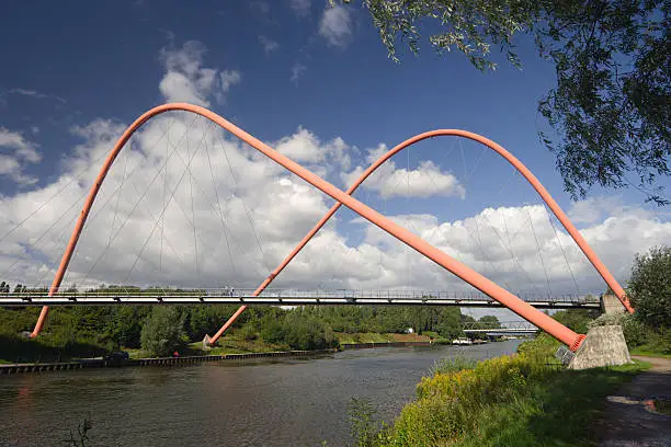An extraordinary suspension bridge crossing a canal.