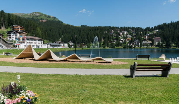 the lakeshore in Arosa with the train and cable railway station in the background Arosa, GR / Switzerland - 24. July, 2019: the lakeshore in Arosa with the train and cable railway station in the background arosa photos stock pictures, royalty-free photos & images