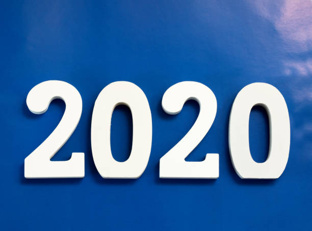 istock Year 2020 made from wooden white numbers on a blue background 1164506378