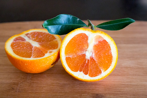 A sliced orange on a wooden board