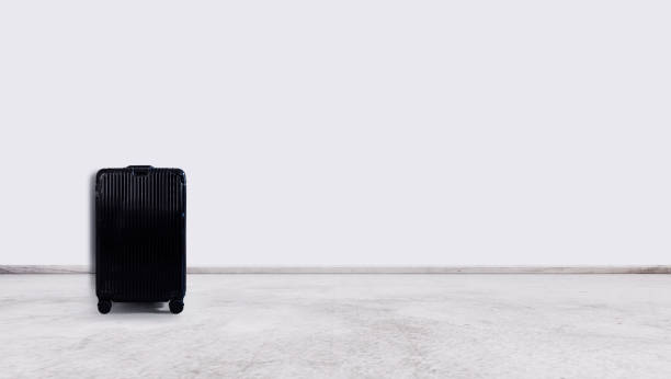 istock Black travel baggage , on white wall and floor 1164513512