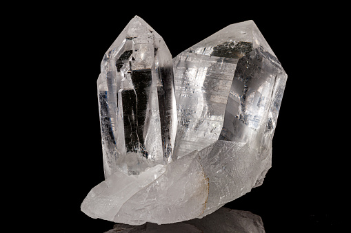 Macro mineral stone rhinestone, rock crystal on a black background close up