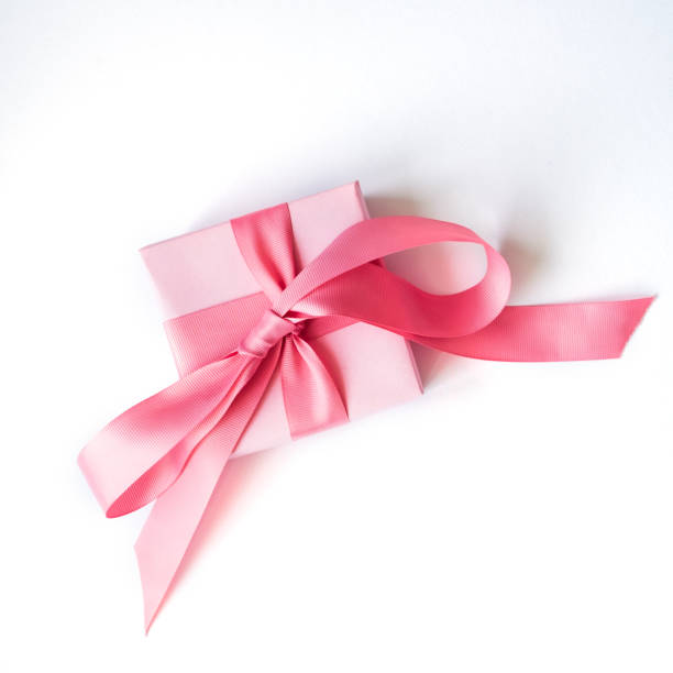 istock Pink gift box with a pink ribbon on a white background . 1164515751