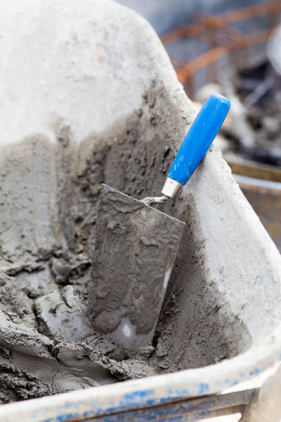 istock Trowel with mortar in wheelbarrow 1164515931