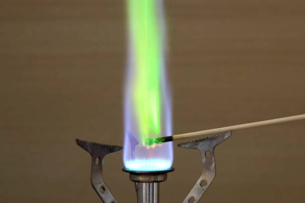 Ignition of copper oxide on a mini burner with a wooden stick. on the mini burner. Chemical experiments.
