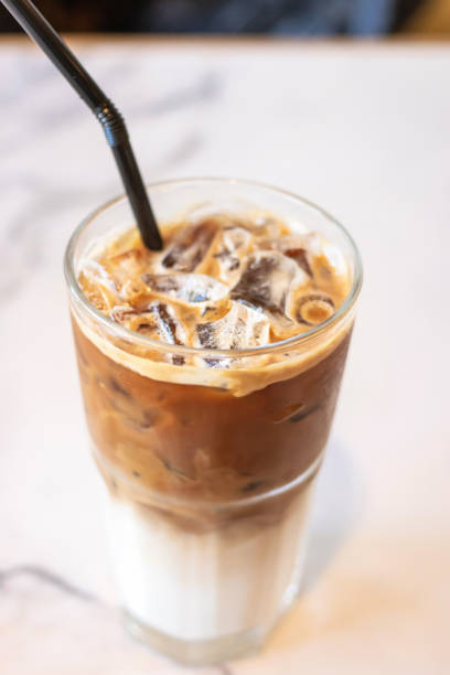 istock Iced coffee glass with black straw on table in cafe and restaurant. 1164519674