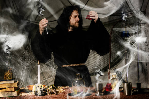 istock The medieval alchemist make magic ritual at the table in his smoke laboratory. 1164519986