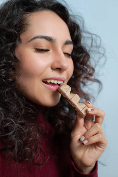 istock Girl eats a chocolate and shows emotions 1164520141
