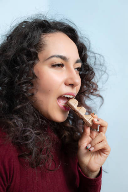istock Girl eats a chocolate and shows emotions 1164520779