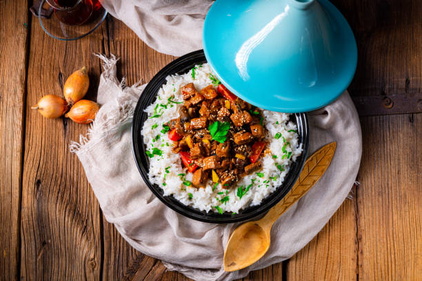 Tajin beef stew with rice paprika and sesame seeds Tajin beef stew with rice paprika and sesame seeds tajine stock pictures, royalty-free photos & images