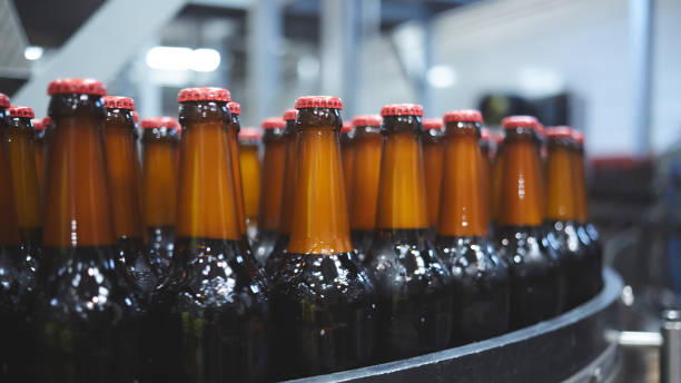 istock Beer bottles on the conveyor belt. Shallow dof. Selective focus. 1164521122