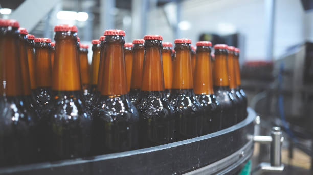 istock Beer bottles on the conveyor belt. Shallow dof. Selective focus. 1164521127
