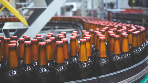 istock Beer bottles on the conveyor belt. Shallow dof. Selective focus. 1164521129