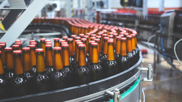 istock Beer bottles on the conveyor belt. Shallow dof. Selective focus. 1164521132