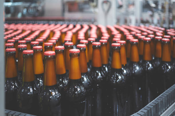 istock Beer bottles on the conveyor belt. Shallow dof. Selective focus. 1164521135