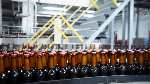 istock Beer bottles on the conveyor belt. Shallow dof. Selective focus. 1164521145