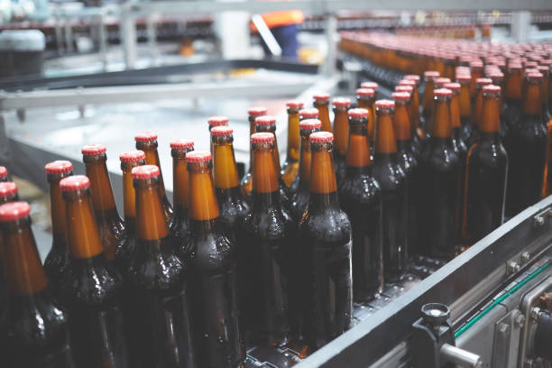 istock Beer bottles on the conveyor belt. Shallow dof. Selective focus. 1164521149