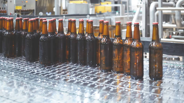 istock Beer bottles on the conveyor belt. Shallow dof. Selective focus. 1164521155