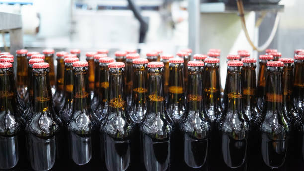 istock Beer bottles on the conveyor belt. Shallow dof. Selective focus. 1164521161