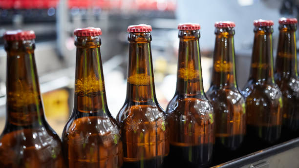 istock Beer bottles on the conveyor belt. Shallow dof. Selective focus. 1164521165