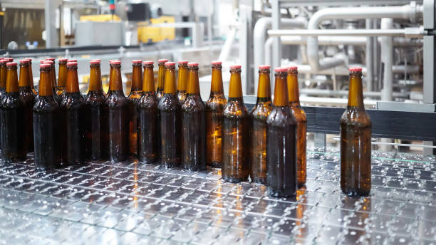 istock Beer bottles on the conveyor belt. Shallow dof. Selective focus. 1164521166