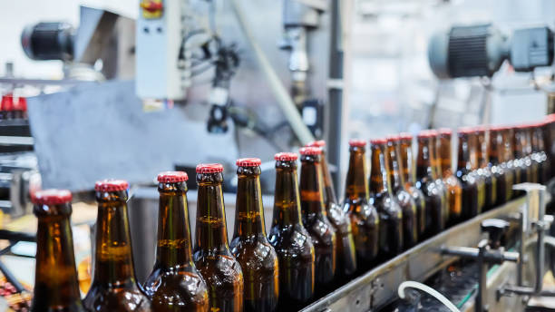 istock Beer bottles on the conveyor belt. Shallow dof. Selective focus. 1164521168