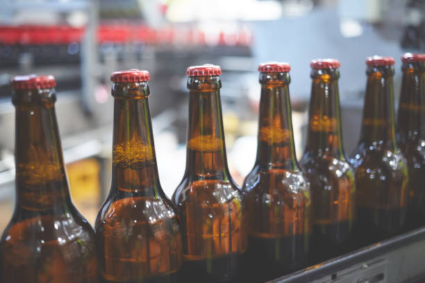 istock Beer bottles on the conveyor belt. Shallow dof. Selective focus. 1164521169