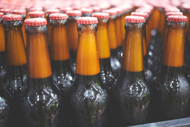 istock Beer bottles on the conveyor belt. Shallow dof. Selective focus. 1164521245